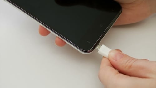 Female Hand Plugging Charger Cell Phone Smartphone