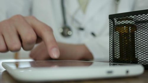 Doctor Using Tablet in Office Setting
