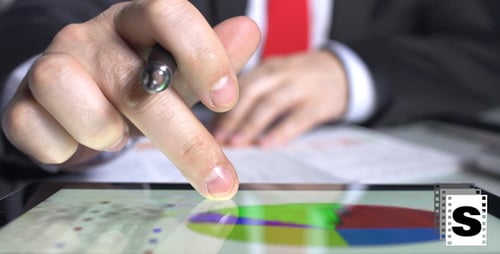 Man Reviews Business Analytics on Tablet