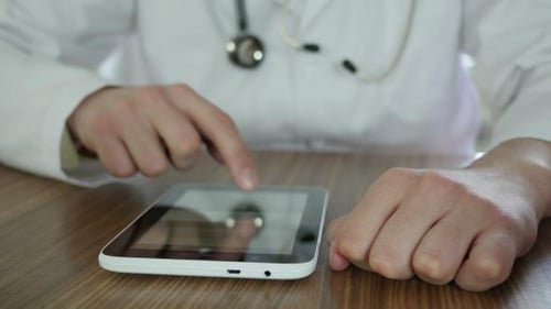 Doctor Typing On Tablet 17