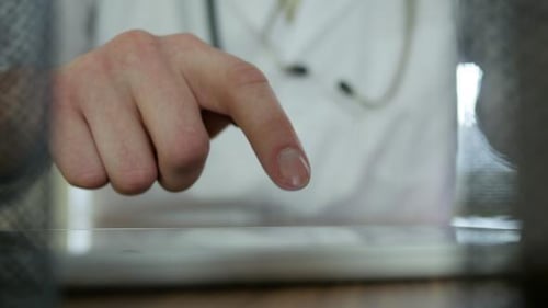 Doctor Typing On Tablet 26