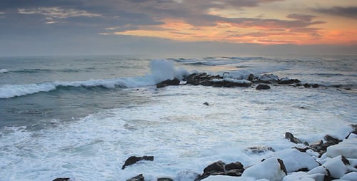 Waves On Rocky Beach Before Sunrise