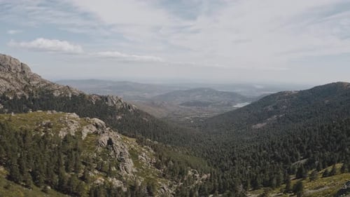 Faceless person on cliff and mountain valley