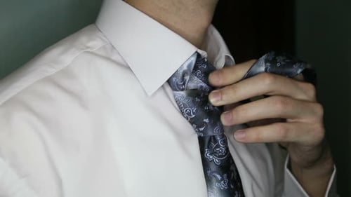 Man Tying Tie in Preparation for Work