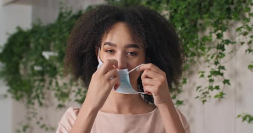 Portrait of Afro American Girl Black Woman Putting on Medical Mask on Face Protects Her Mouth and