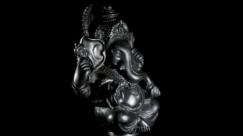 Rotating Dark Statue of Ganesha on Black Background