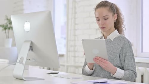 Beautiful Young Latin Woman Using Tablet in Modern Office