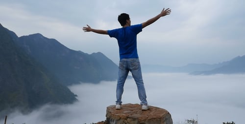 Man At The Top Of Mountain With Clouds