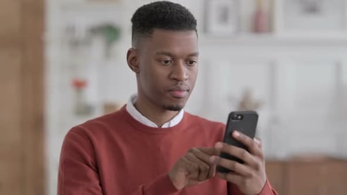 Young Adult Celebrating Success on Mobile Phone