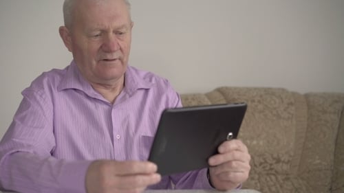 Senior Man Using Tablet Indoors