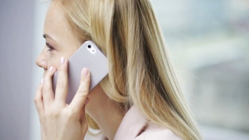 Woman with Blond Hair Talking on Mobile Phone