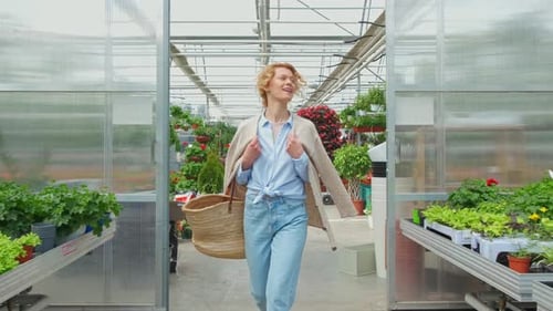Curly Blonde Woman Shopping for Decorative Plants on Floristic Greenhouse Market