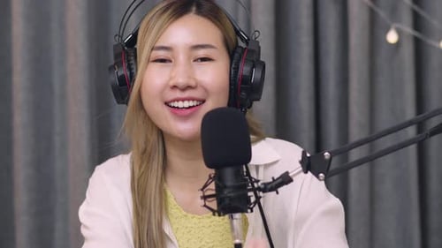 Woman Smiling and Speaking into Microphone
