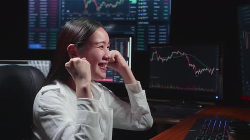 Woman Celebrates Stock Market Success in Urban Office