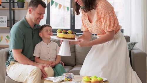 Family Celebrates Birthday with Cake at Home