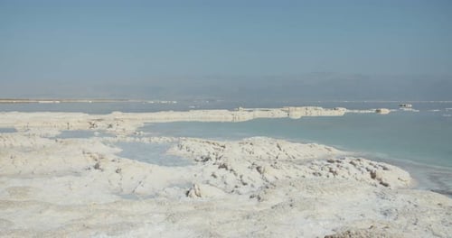 Tracking shot of salt deposits on the banks of the Dead Sea in israel