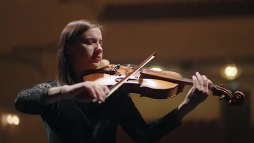 Woman Playing Violin in Music Hall