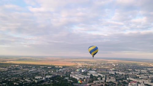 Aerial Drone View of Colorful Air Balloon Flying Over Green Park in Small European City at Summer