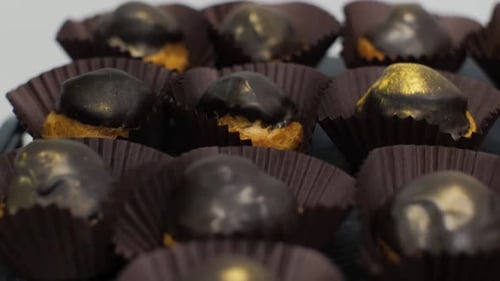 Chocolate Covered Pastries in Brown Paper Cups