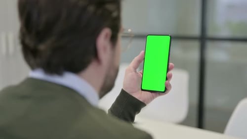 Young Adult Using Phone with Green Screen