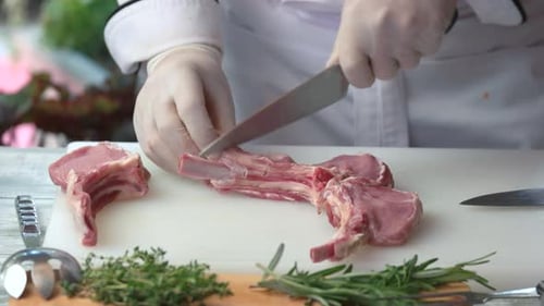 Chef Cuts Rack of Lamb for Cooking Preparation