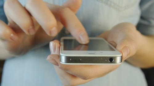 Hands Interacting with a Smartphone in Close-Up