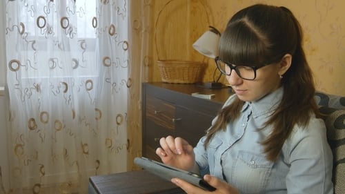 Woman Using Tablet Device Indoors at Home