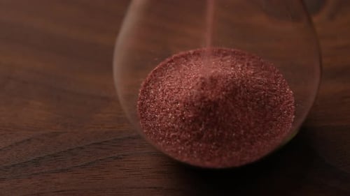 Hourglass with Maroon Sand Flowing