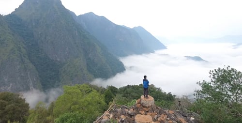 Aerial View Man At The Top Of Mountain Clouds