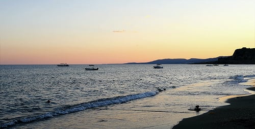 Peaceful Beach at Sunrise or Sunset with Boats