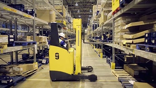 Warehouse Worker Loading Cargo on Rack