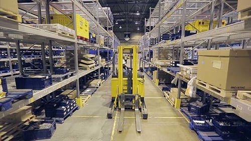 Worker On Autoloader Taking Box From Rack
