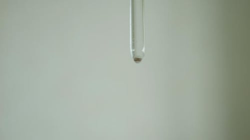 Close Up of Glass Pipette with Dark Liquid