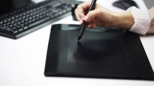 Woman Using Digital Pen and Drawing Tablet