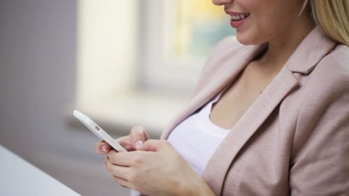 Woman Uses Smartphone in Natural Light