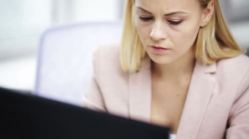 Stressed Businesswoman With Computer At Office