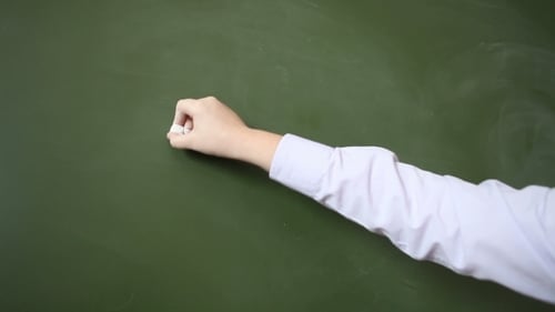 Writing ABC Letters on Green Chalkboard