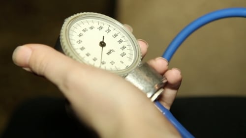 Hand Holding Blood Pressure Gauge Close Up