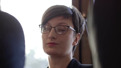 Businesswoman Speaking at a Corporate Meeting Indoors
