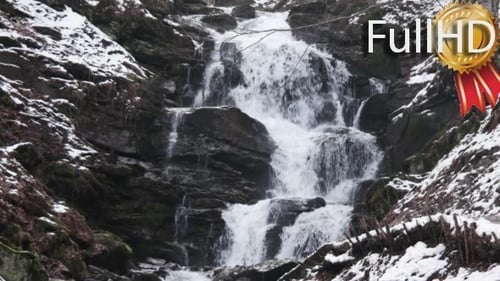 Winter Waterfall Cascading Down Rocky Landscape