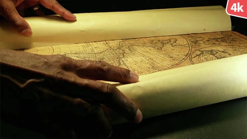 Hand Unrolling Antique World Map Scroll