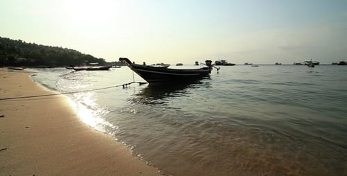 Tropical Beach with Boat at Sunrise or Sunset