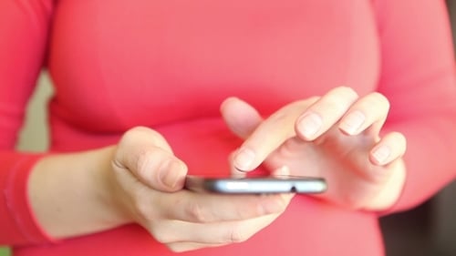 Woman Using Smart Phone Close Up Indoors
