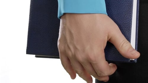 Adult Hand Holding Blue Folder Close Up