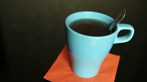 Stirring Tea In a Blue Cup