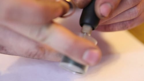 Ring Polishing With Power Tool on White Table
