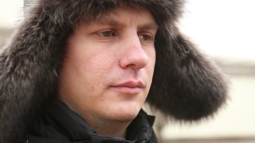 Man Wearing Fur Hat Smiling Outdoors Close Up