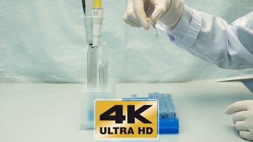 Lab Technician Arranging Test Tubes for Research