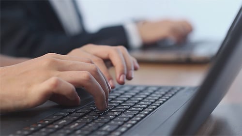 Business People Typing on a Laptops