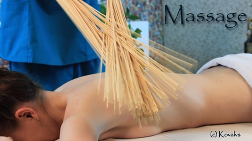 Woman Receiving Relaxing Bamboo Massage at Spa